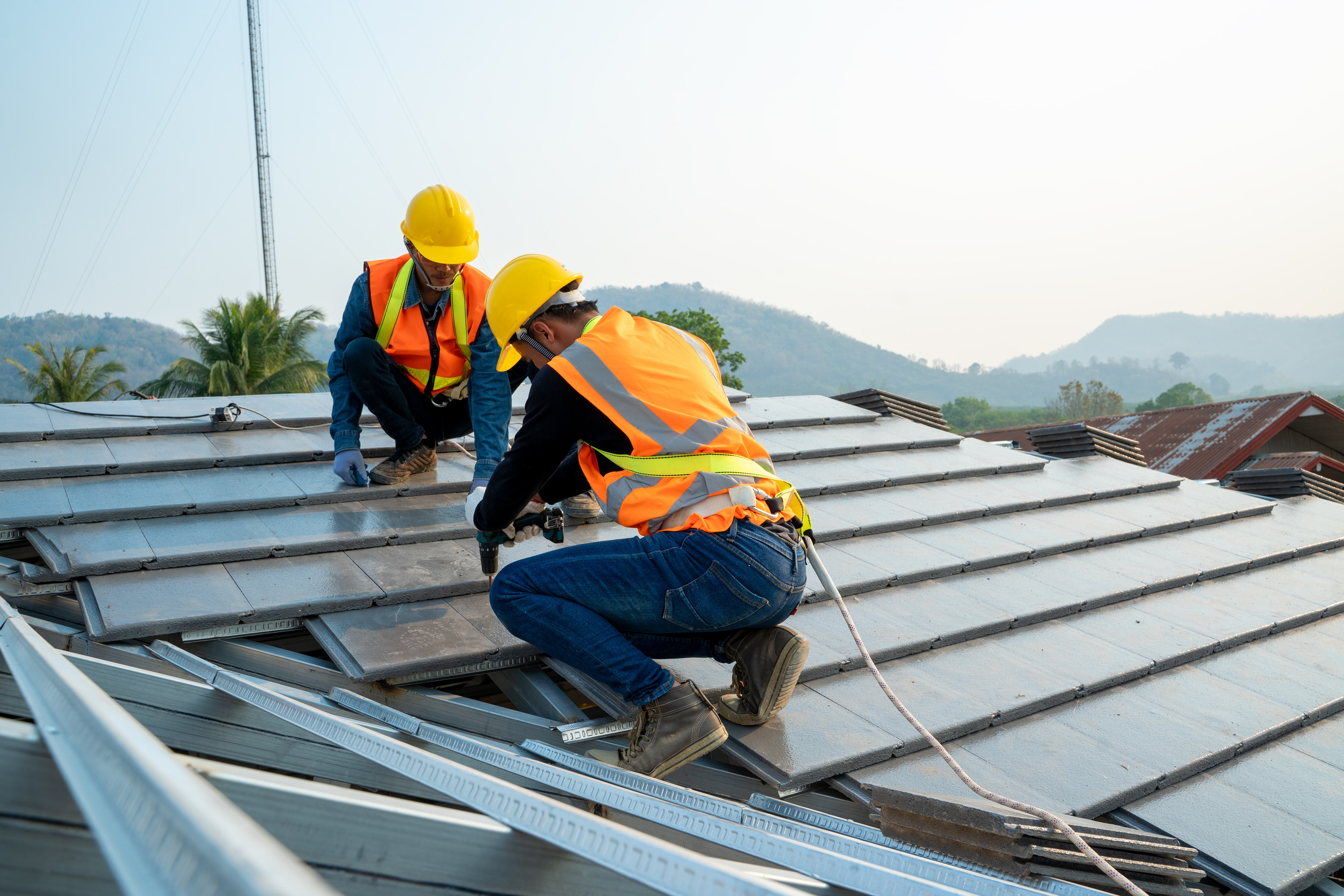 Workers do repair work on a roof.